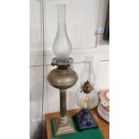 A Victorian Corinthian column brass oil lamp with glass shade, 73cm and another oil lamp with