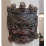 A carved and painted wood Eastern face mask (a/f)