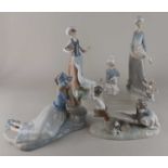 Four Lladro procelain figures to include a figure group of a boy and girl on a see-saw, together