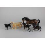 Five Beswick models of animals comprising a lion cub 10cm high, a black labrador 8cm, a Shetland