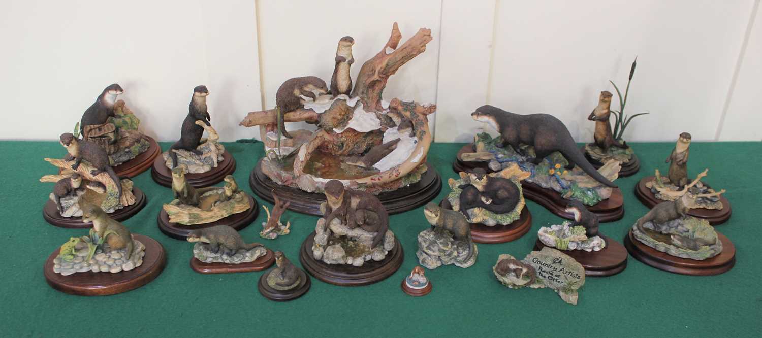 A collection of Border Fine Arts and Country Artists models of otters, some boxed