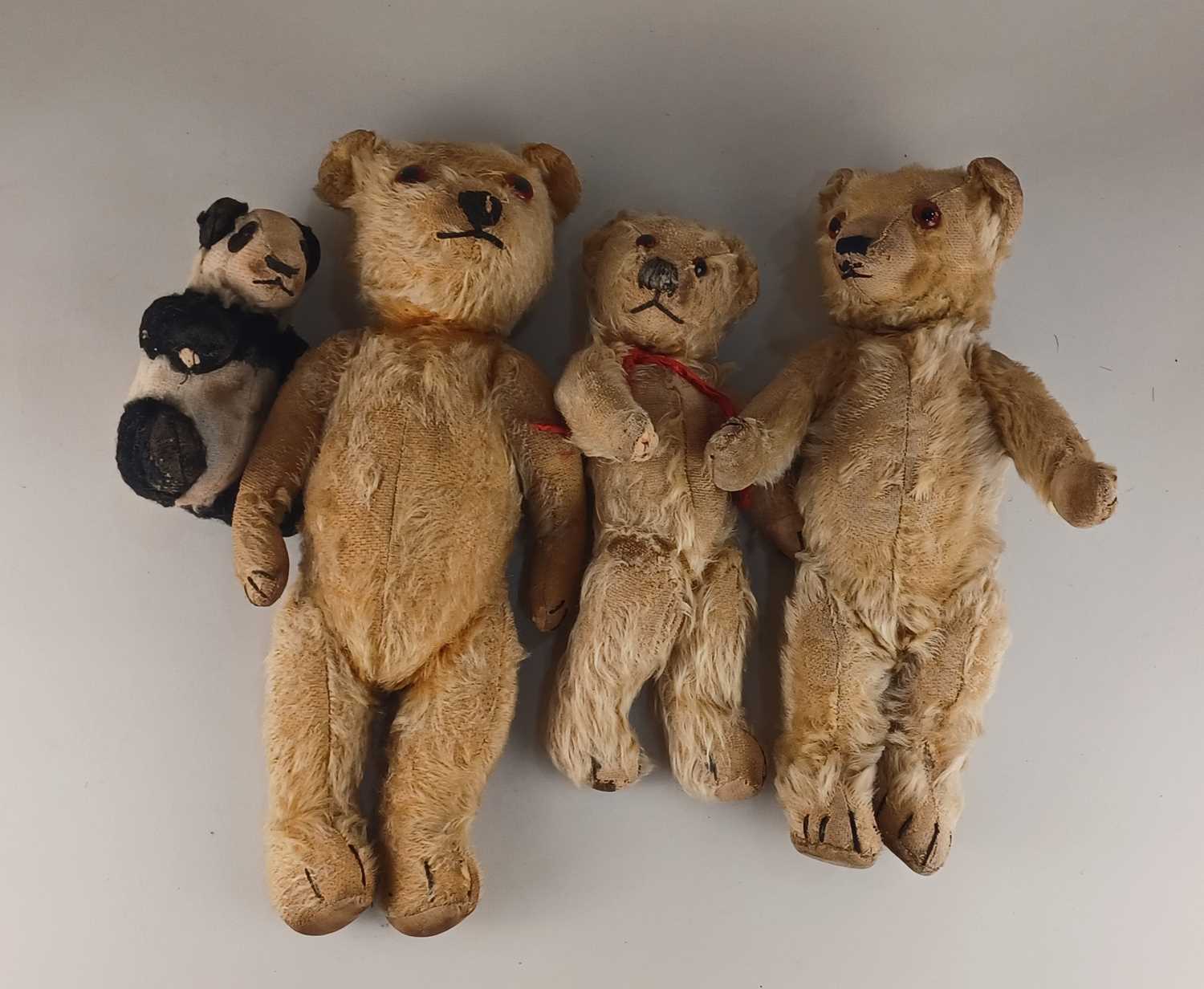 Three teddy bears with jointed limbs, largest 37cm, and a Chad Valley stuffed panda (a/f)