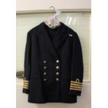 A British Royal Navy Captain's dress uniform jacket and trousers, and assorted buttons and