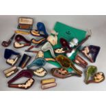 A collection of cased meerschaum pipes, other pipes and cigarette holders, most cased, one with