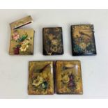 A collection of three Victorian papier mache card cases and a notebook decorated with birds and