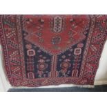 Three Persian rugs including a crimson ground rug with lozenge design, (a/f) 176cm by 97cm