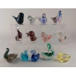 A collection of thirteen various coloured glass bird shaped paperweights