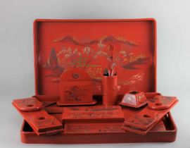 A collection of red lacquered Chinoiserie desk ware to include book stands, pen holders and letter
