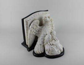 A ceramic eagle wall plinth on wooden mount 28cm wide