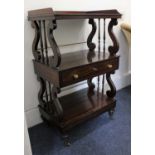 A Victorian rosewood three tier what-not double sided with gallery top and central drawer on