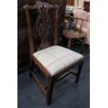 A Chippendale style single dining chair with carved ribbon back, drop in upholstered seat on