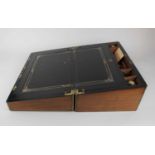 A large Victorian walnut and brass bound writing slope, the interior with leather inset writing