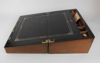 A large Victorian walnut and brass bound writing slope, the interior with leather inset writing