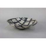 Carolyn Genders (b1957) a studio pottery dish with grey and grid pattern incised signature and