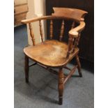 A Captains chair with solid seat and turned supports