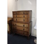 An early 20th century oak chest on chest of three drawers over three further drawers with pierced