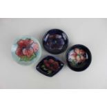 Four Moorcroft pottery pin dishes, to include Hibscus pattern largest 9cm diameter