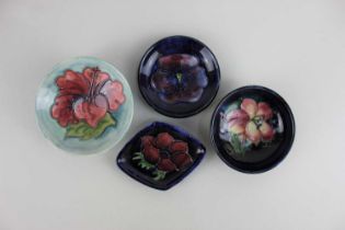 Four Moorcroft pottery pin dishes, to include Hibscus pattern largest 9cm diameter