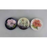 Three Moorcroft pottery trinket dishes; to include Magnolia and Hibiscus patterns
