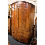 A 19th century mahogany bowfront linen press, two moulded cupboard doors enclosing interior