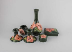 A Moorcroft pottery pink Hibiscus pattern vase 21.5cm high, pair of candlesticks, small vase,