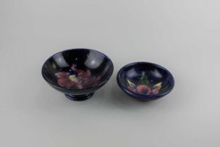 Two Moorcroft pottery Orchid pattern bowls, blue ground, largest 14cm diameter