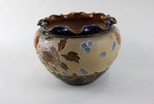 A Doulton Lambeth Slaters Patent jardiniere with wavy rim and floral decoration on brown textured