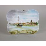 A handpainted porcelain plaque decorated with a view of Bosham Quay inscribed 'Bosham near