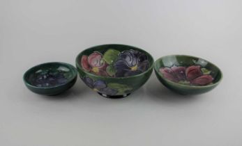 Two Moorcroft pottery Clematis pattern bowls largest 16cm diameter, and a Moorcroft pottery