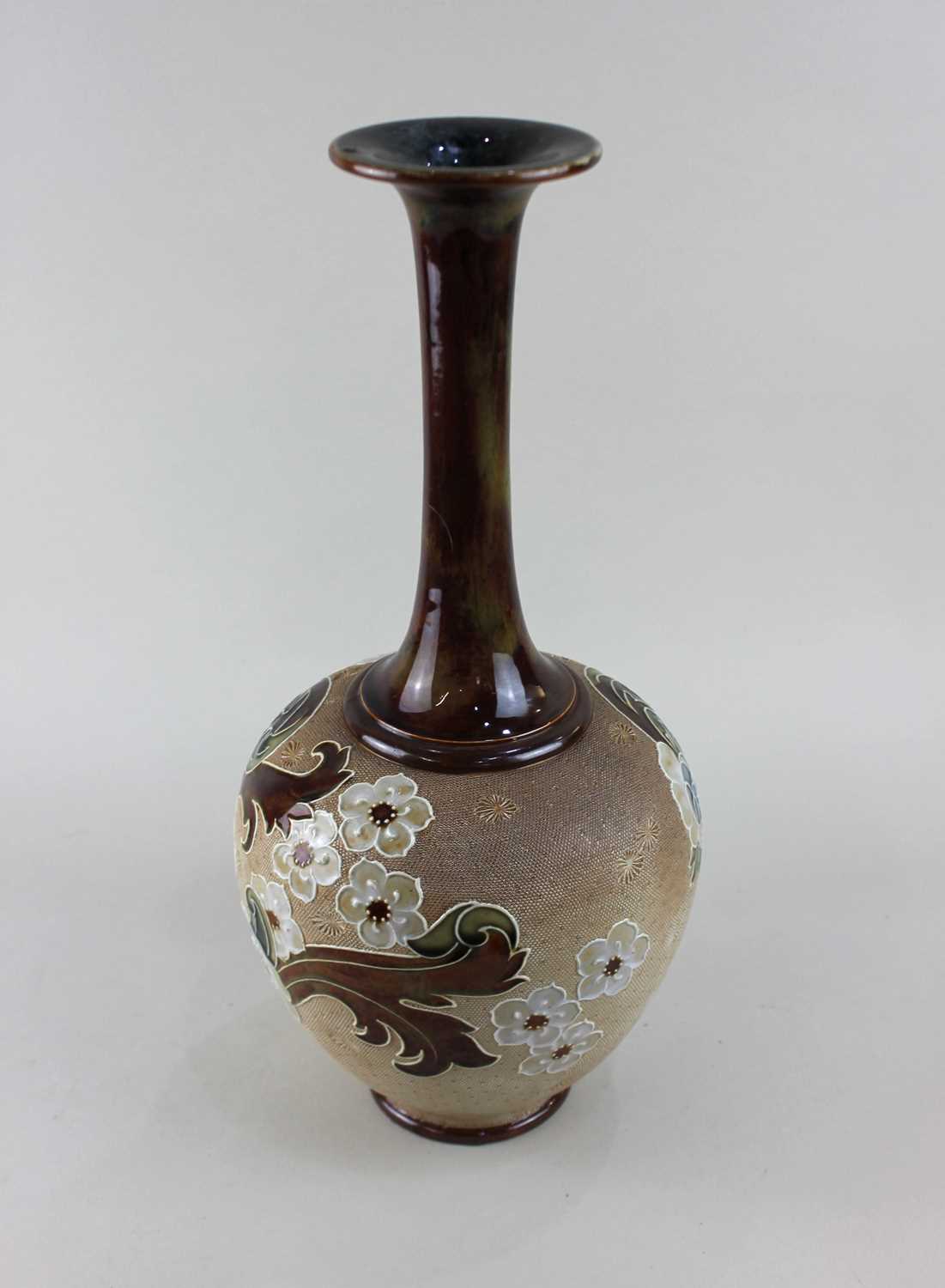 A Royal Doulton Slaters Patent stoneware bottle vase decorated with blossom and scrolling foliage,