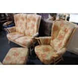 An Ercol two seat settee with matching armchair and footstool with stick back and arm supports,