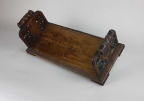 A Victorian rosewood carved bookstand by Daniel Ruddle March 1873, with inlaid lettering 'TRUTH',