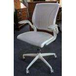A Humanscale white office chair on swivel base