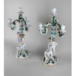 A pair of Augustus Rex style porcelain three branch candelabra each with applied flowers and