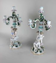 A pair of Augustus Rex style porcelain three branch candelabra each with applied flowers and