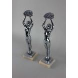 After Jacques Limousin, a pair of chrome metal nude figures holding baskets of flowers, 35cm high