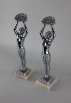 After Jacques Limousin, a pair of chrome metal nude figures holding baskets of flowers, 35cm high