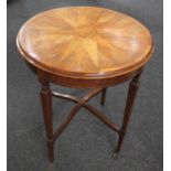 An Edwardian mahogany occasional table, the circular top inlaid with a sunburst motif in different