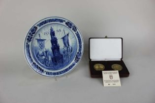 A Delft commemorative plate for the Olympics, Amsterdam 1928, together with a cased set of two