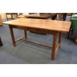 A rustic fruitwood rectangular dining table with small drawer on square chamfered legs with