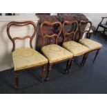 A set of four Victoria rosewood balloon back dining chairs on turned legs (a/f)