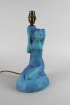 A figural blue ceramic table lamp in the form of a kneeling figure 33cm high including fitting