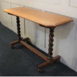 An oak side table spiral turned end supports with uniting stretcher and bun feet, 118cm