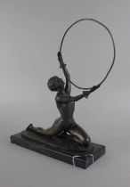 After Ferdinand Preiss, a cast bronze model of a girl holding a hoop, with signed 'F Preiss' and