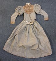 A 19th century brown silk two piece lady's day dress, the jacket with patterned front panel and