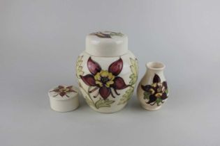 A Moorcroft pottery 'Columbine' pattern ginger jar and cover, small vase and trinket pot tallest