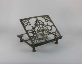 A brass missal stand with pierced decoration and central letters 'IHS' 27.4cm by 24cm