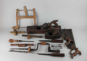 A small collection of woodworking tools to include handsaws, wooden block planes, brace drill, bits,