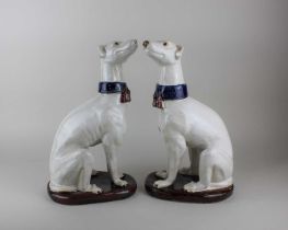 A pair of majolica greyhounds, possibly Italian, 36cm high (a/f - one with small chip to ear)