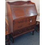 An early 20th century mahogany bureau with panelled fall front enclosing fitted interior with